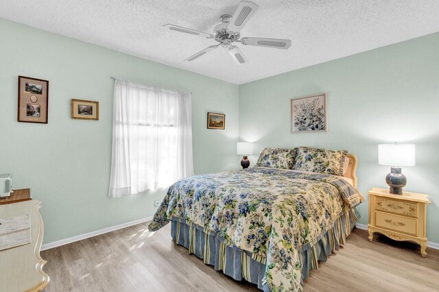 9 Plantation Dr Unit 104, Vero Beach, FL 32966 - bedroom with baseboards, wood finished floors, and a textured ceiling