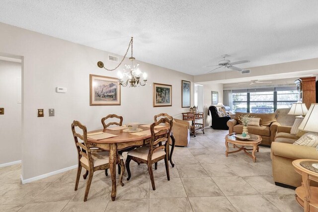 9 Plantation Dr Unit 104, Vero Beach, FL 32966 - dining space featuring visible vents, ceiling fan with notable chandelier, baseboards, and a textured ceiling