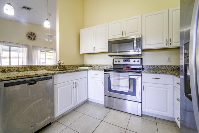 kitchen with a ceiling fan, visible vents, appliances with stainless steel finishes, a sink, and light tile patterned floors