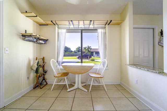 dining area featuring baseboards and light tile patterned floors