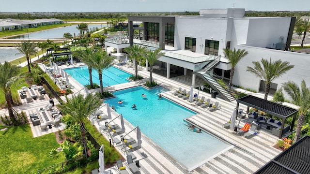 pool with a water view and a patio area