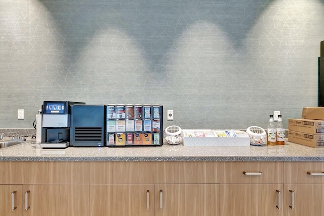 interior space with light brown cabinetry and light stone counters