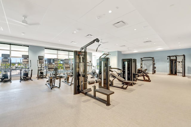 gym with baseboards, visible vents, and carpet