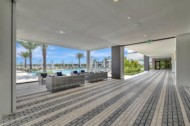 wooden terrace with a community pool and an outdoor hangout area