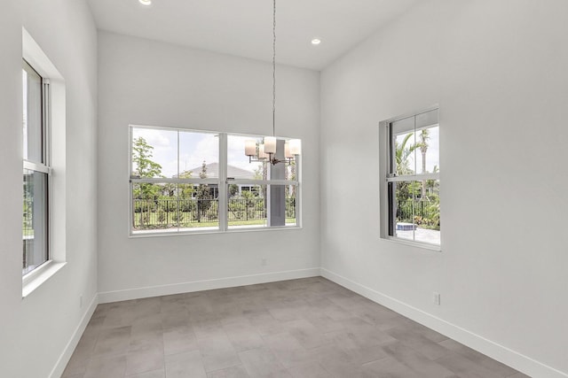 10130 Driftwood Way, Palm Beach Gardens, FL 33412 - unfurnished room with a chandelier, baseboards, recessed lighting, and a high ceiling