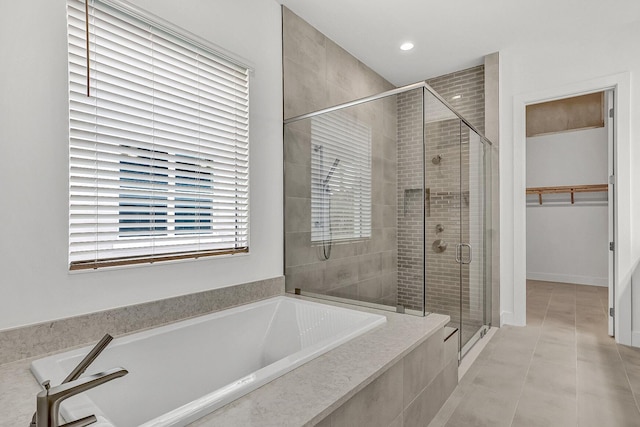 10130 Driftwood Way, Palm Beach Gardens, FL 33412 - bathroom featuring a bath, a stall shower, a walk in closet, tile patterned flooring, and recessed lighting