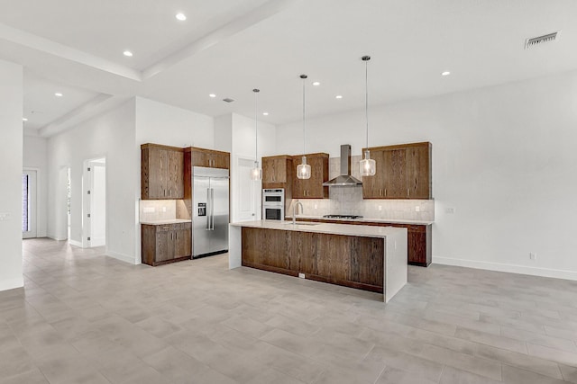 10130 Driftwood Way, Palm Beach Gardens, FL 33412 - kitchen featuring built in fridge, wall chimney exhaust hood, a sink, decorative backsplash, and a towering ceiling