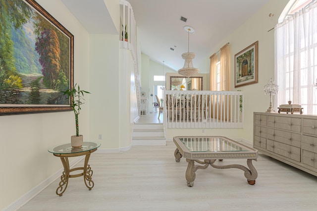 hall with wood finished floors, plenty of natural light, and baseboards