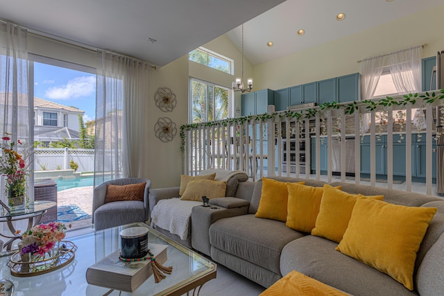 living area featuring a chandelier, high vaulted ceiling, and recessed lighting