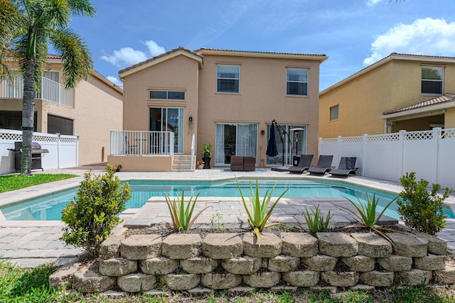 view of swimming pool featuring a fenced backyard and a patio area