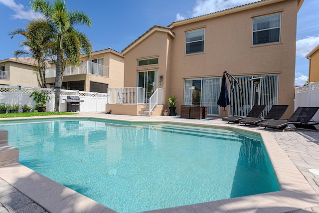 view of pool featuring fence and area for grilling