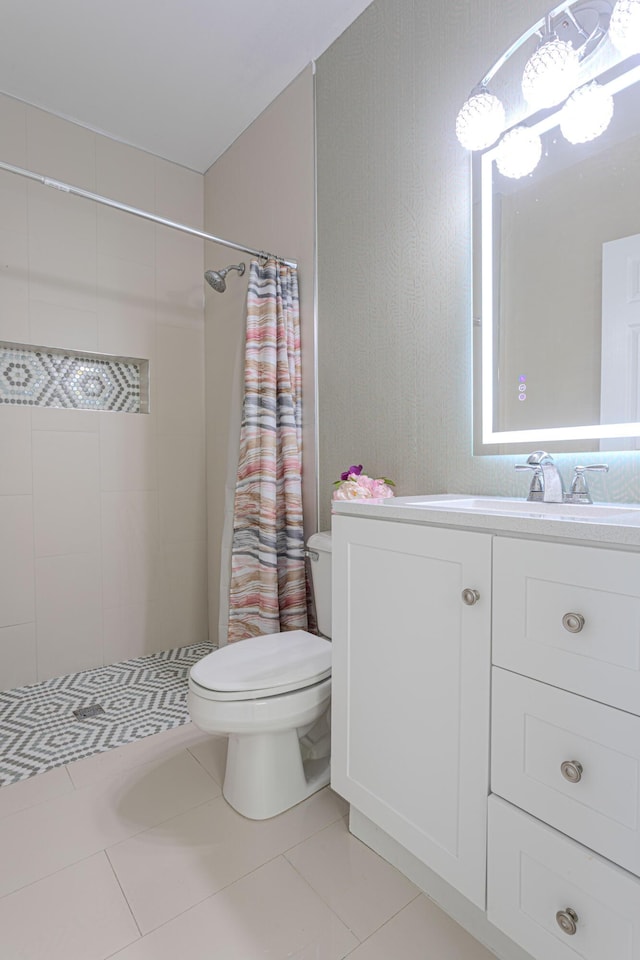 bathroom featuring toilet, a tile shower, vanity, tile patterned floors, and a chandelier