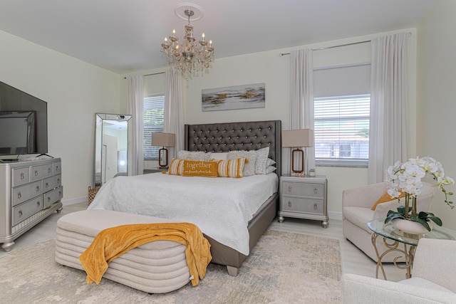 bedroom featuring multiple windows, a chandelier, baseboards, and wood finished floors