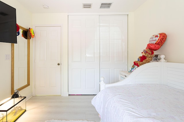 bedroom featuring light wood-style flooring and a closet