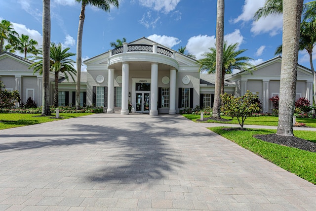 view of building exterior featuring decorative driveway