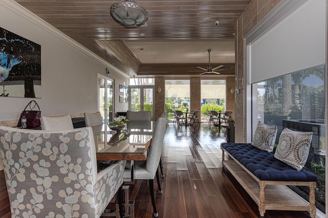 dining space featuring hardwood / wood-style flooring, ornamental molding, ceiling fan, and wood ceiling