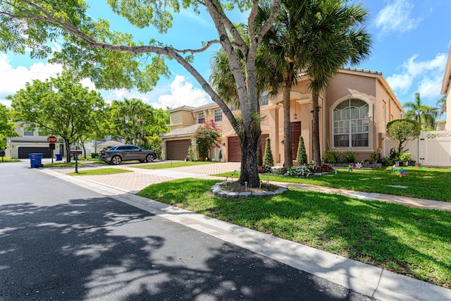 view of front of home with decorative driveway, stucco siding, and an attached garage