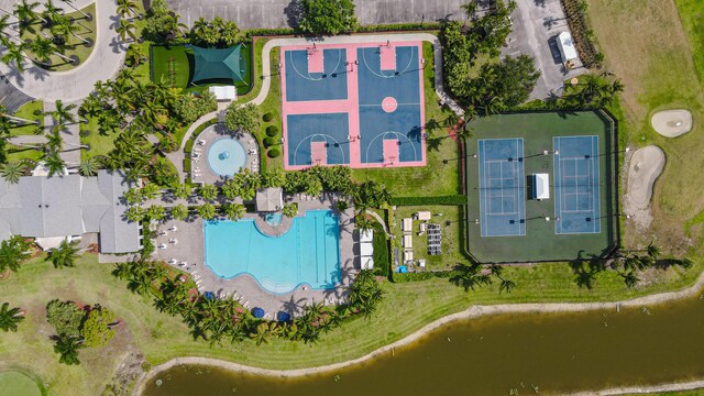 bird's eye view of a pool area and a large body of water