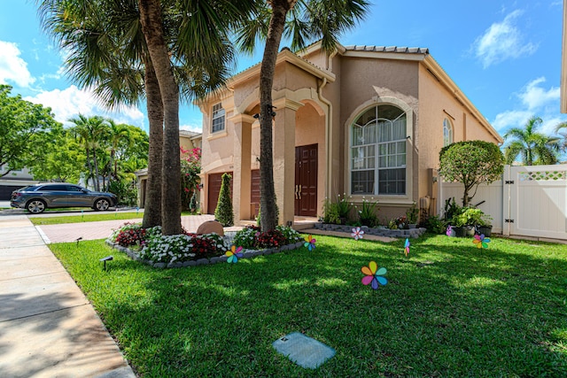 view of side of home featuring a gate and stucco siding