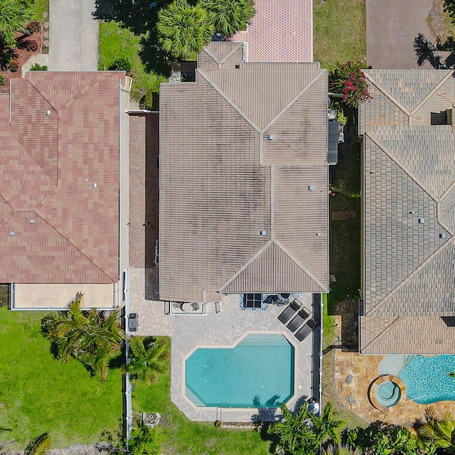 aerial view of property and surrounding area featuring a pool area