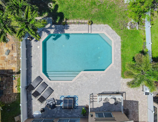 aerial view of property and surrounding area featuring a pool area