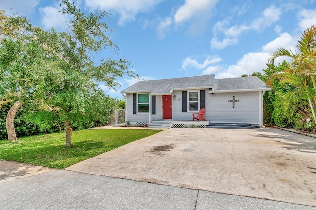 850 Green St, West Palm Beach, FL 33405 - ranch-style house with a porch, roof with shingles, and a front lawn