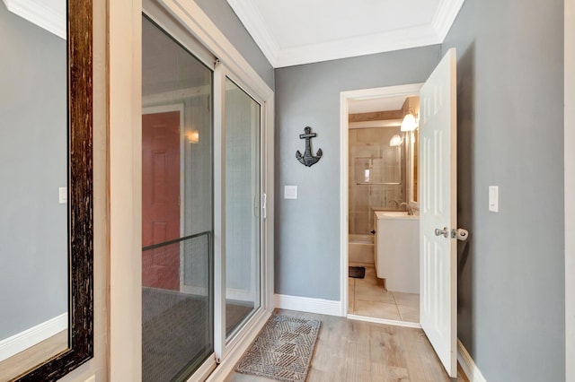 850 Green St, West Palm Beach, FL 33405 - full bath featuring crown molding, a shower with door, wood finished floors, baseboards, and a sink