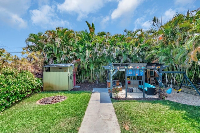 850 Green St, West Palm Beach, FL 33405 - view of yard with a storage unit, an outdoor structure, and a playground