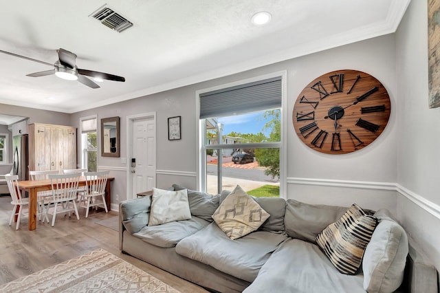 850 Green St, West Palm Beach, FL 33405 - living room featuring visible vents, light wood finished floors, ceiling fan, and a healthy amount of sunlight
