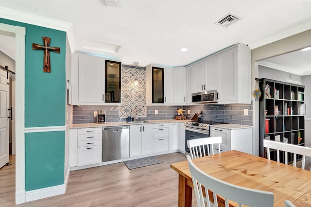 850 Green St, West Palm Beach, FL 33405 - kitchen with visible vents, light countertops, tasteful backsplash, and stainless steel appliances