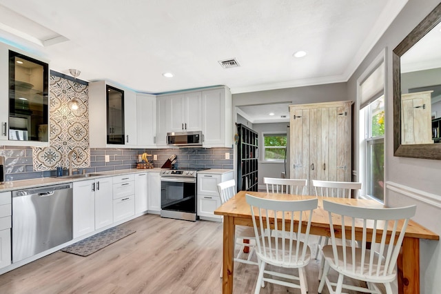 850 Green St, West Palm Beach, FL 33405 - kitchen with decorative backsplash, visible vents, appliances with stainless steel finishes, a sink, and light countertops