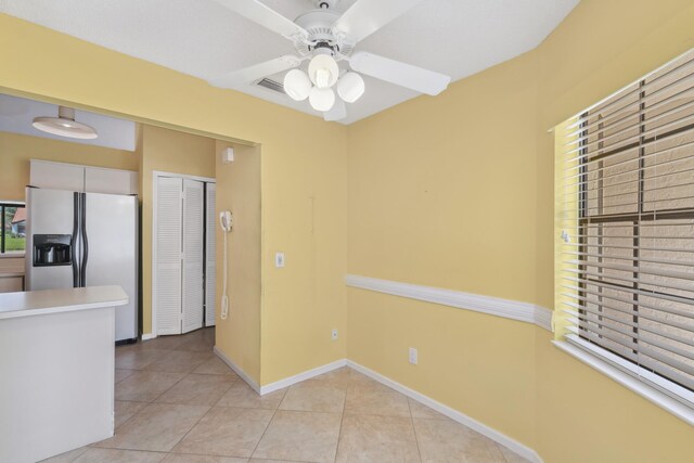 5942 Parkwalk Cir W, Boynton Beach, FL 33472 - kitchen with light tile patterned flooring, a ceiling fan, baseboards, and stainless steel fridge with ice dispenser