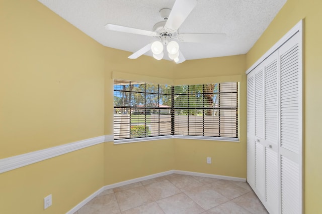 5942 Parkwalk Cir W, Boynton Beach, FL 33472 - unfurnished bedroom with a textured ceiling, a closet, baseboards, and light tile patterned floors