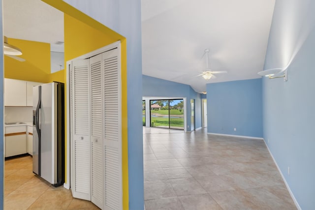 5942 Parkwalk Cir W, Boynton Beach, FL 33472 - corridor featuring lofted ceiling, baseboards, and light tile patterned floors