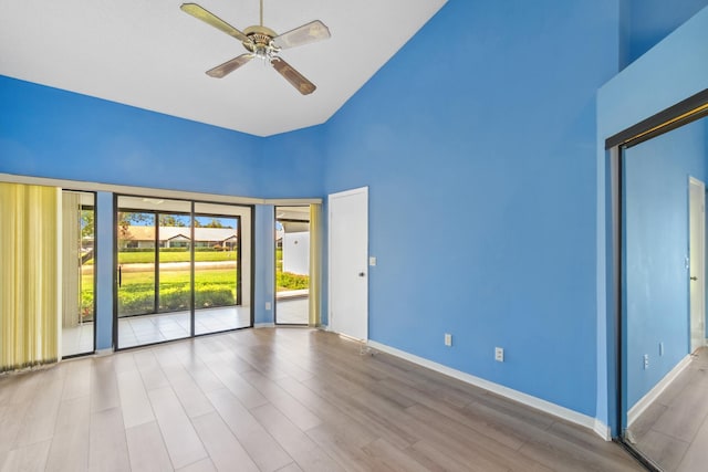 5942 Parkwalk Cir W, Boynton Beach, FL 33472 - empty room featuring baseboards, wood finished floors, high vaulted ceiling, and ceiling fan