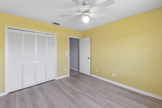 5942 Parkwalk Cir W, Boynton Beach, FL 33472 - unfurnished bedroom with baseboards, wood finished floors, visible vents, and a closet