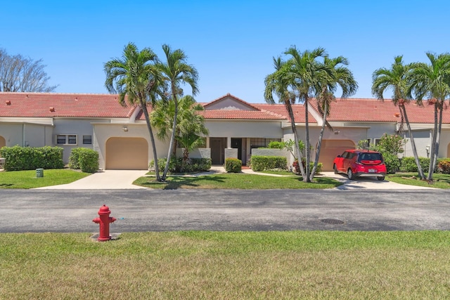 5942 Parkwalk Cir W, Boynton Beach, FL 33472 - view of front of house with stucco siding, a tile roof, concrete driveway, and a garage