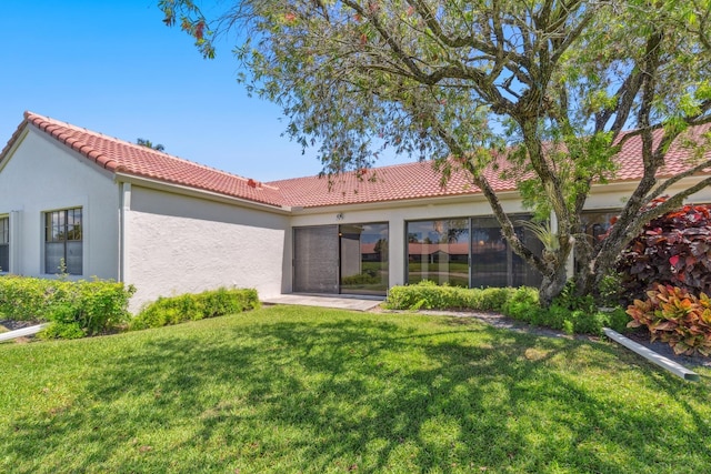 5942 Parkwalk Cir W, Boynton Beach, FL 33472 - rear view of property featuring stucco siding, a yard, and a tiled roof