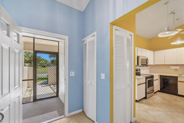 5942 Parkwalk Cir W, Boynton Beach, FL 33472 - entryway featuring baseboards, a high ceiling, and light tile patterned floors