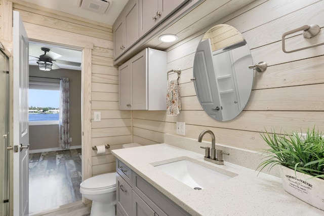 1116 Lake Ter Unit 203, Boynton Beach, FL 33426 - bathroom featuring vanity, toilet, a water view, wood finished floors, and baseboards