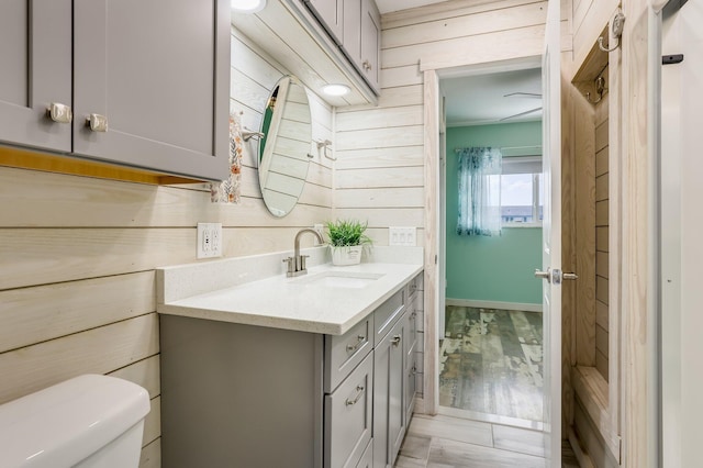 1116 Lake Ter Unit 203, Boynton Beach, FL 33426 - bathroom with vanity, toilet, and wooden walls