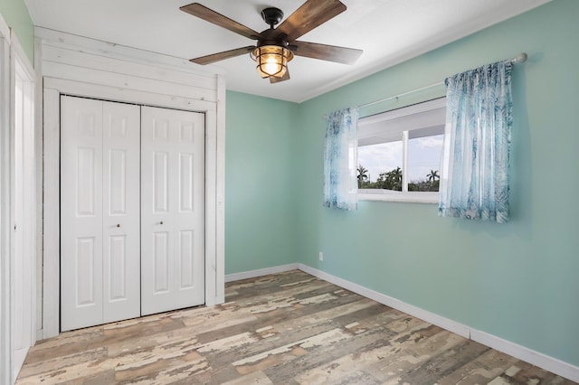 1116 Lake Ter Unit 203, Boynton Beach, FL 33426 - unfurnished bedroom with a closet, wood finished floors, baseboards, and a ceiling fan