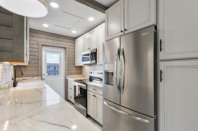 1116 Lake Ter Unit 203, Boynton Beach, FL 33426 - kitchen featuring appliances with stainless steel finishes, a sink, backsplash, light stone counters, and recessed lighting