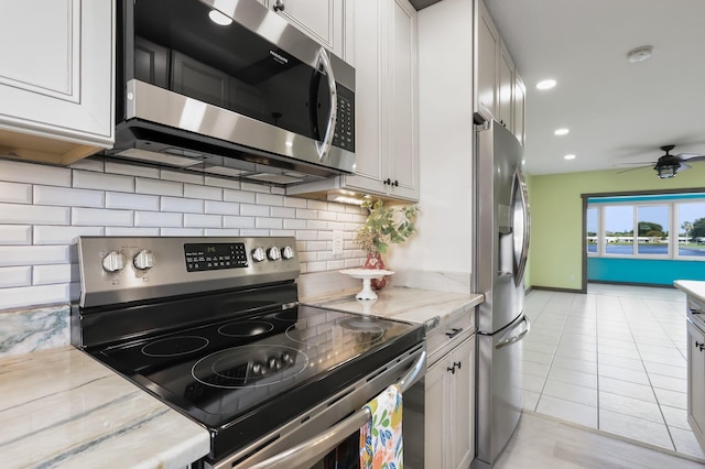 1116 Lake Ter Unit 203, Boynton Beach, FL 33426 - kitchen with appliances with stainless steel finishes, backsplash, ceiling fan, light stone countertops, and recessed lighting