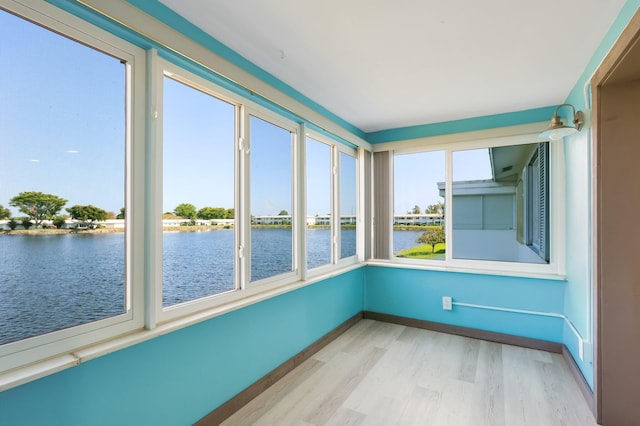 1116 Lake Ter Unit 203, Boynton Beach, FL 33426 - unfurnished sunroom with a water view, wood finished floors, and baseboards