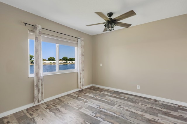 1116 Lake Ter Unit 203, Boynton Beach, FL 33426 - unfurnished room with a ceiling fan, wood finished floors, baseboards, and a water view