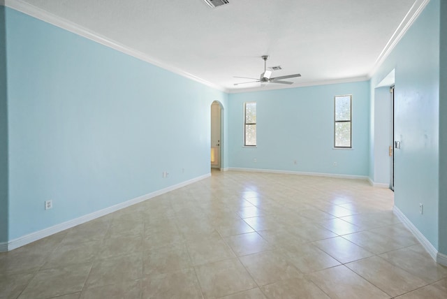 empty room with arched walkways, ceiling fan, ornamental molding, baseboards, and light tile patterned flooring