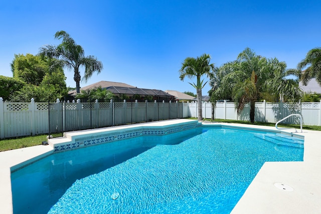 view of swimming pool featuring fence