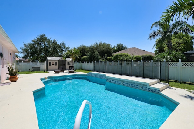 view of pool featuring a fenced backyard, a shed, an outdoor structure, and a patio