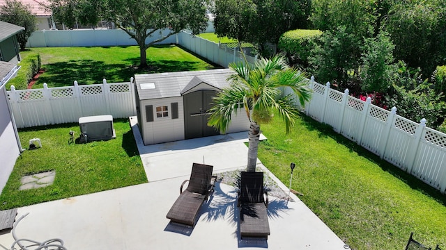 view of yard featuring a shed, an outbuilding, and a patio